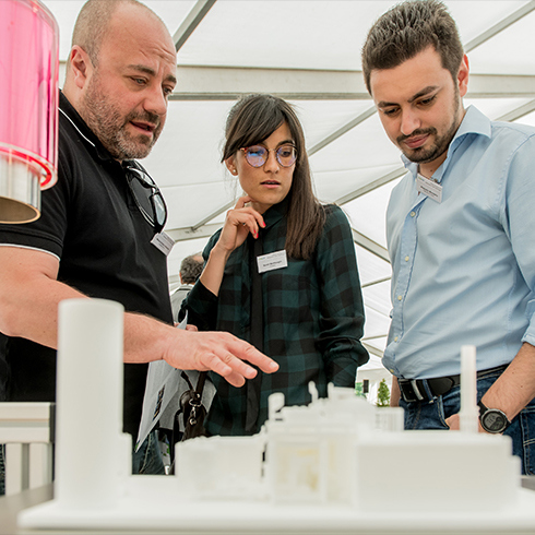 Three people working with a model